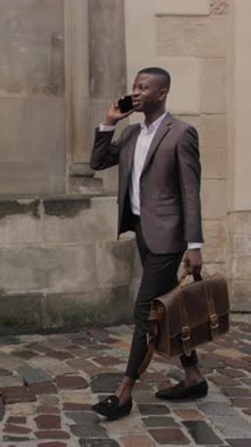 Afro American Man in Suit Talking on Mobile on Street