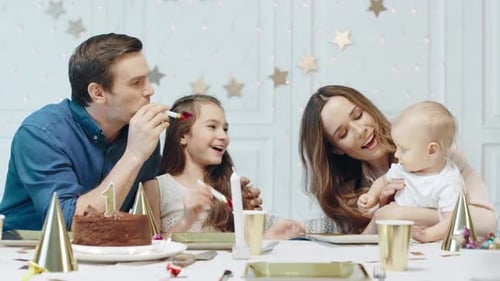 Happy Family Celebrating Birthday at Table