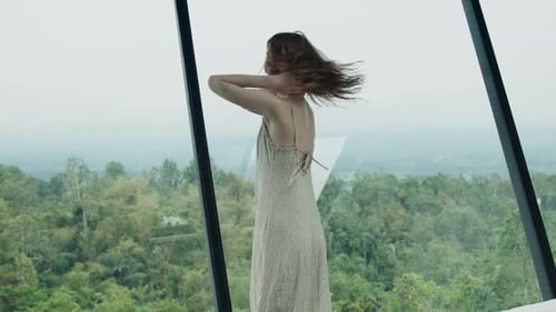 Woman Dancing in Flowing Dress with Panoramic Nature View