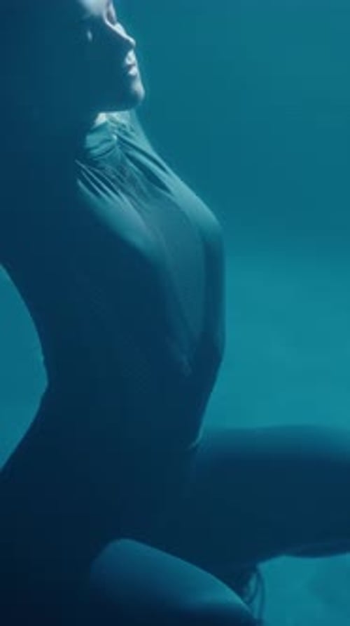 Woman Posing in Dark Bodysuit Underwater