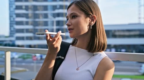 Young Woman Using Voice Recognition on Phone