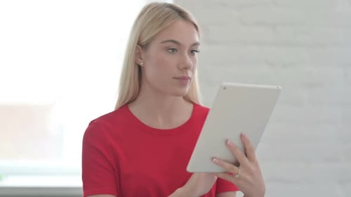 Young Woman Using Tablet Technology at Home
