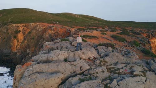 Calm Person Relaxing Rocky Highland at Seashore Man Standing Volcanic Cliffs