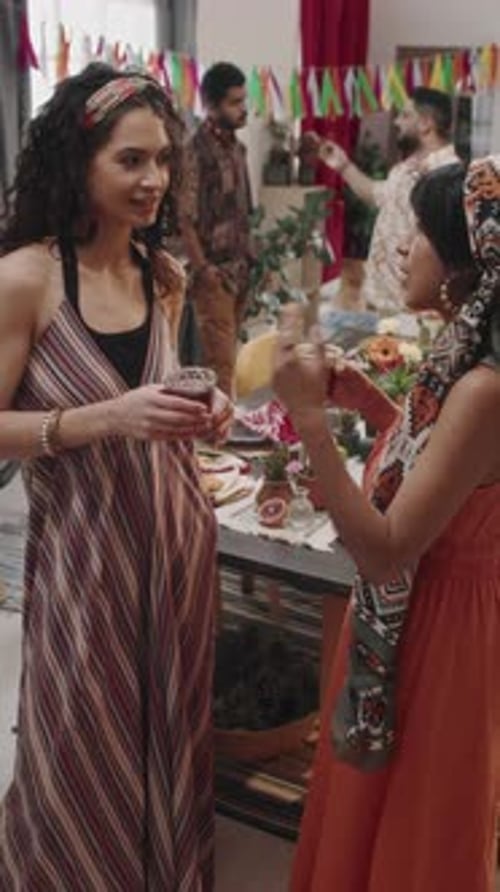 Friends at Party Talk and Hold Drinks