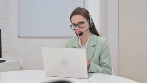 Woman with Headset in Call Center Doing Video Chat at Work