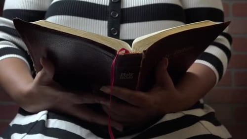Woman Reading Holy Bible in a Close Up Shot