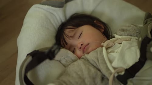 mother putting her child to sleep