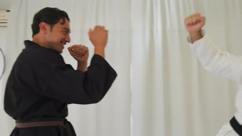Two Young Adult Men Practice Karate Skills
