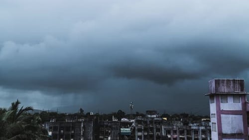 Time lapse of rain, shot in 4k. Dramatic dark clouds and falling rain over city in the rainy season.