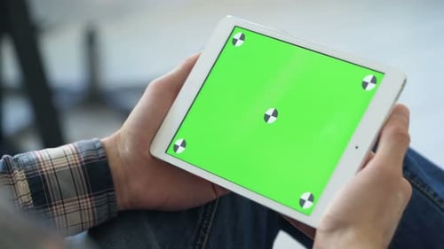 Man Holds Tablet with Chroma Key Screen in Home