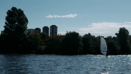 Surfer Windsurfing on River in . View of River with Sportsman