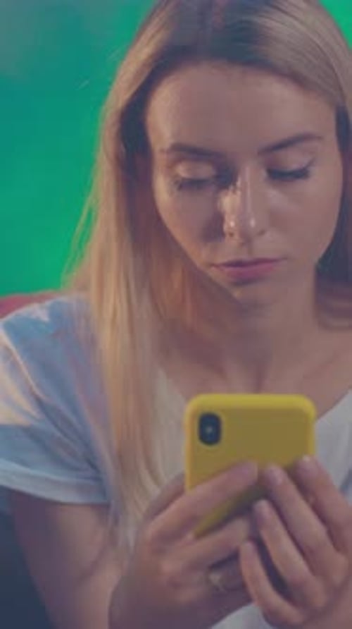 Woman Using Smartphone with Friends in Urban Setting