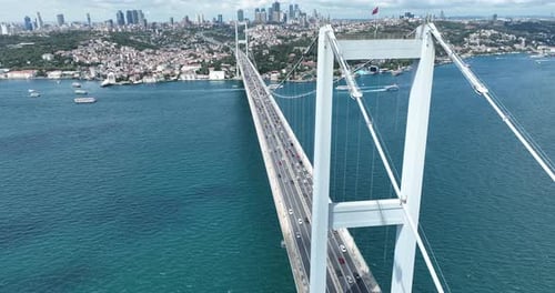 Istanbul Bosphorus Bridge and City Skyline in Background with Turkish Flag at Beautiful Sunset