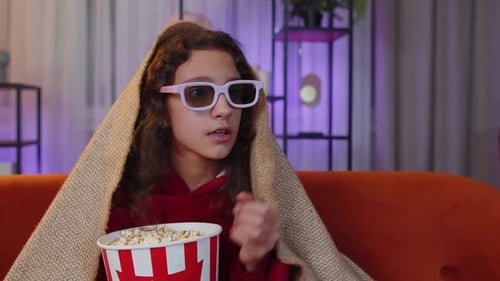 Girl Watching a Scary Movie with 3D Glasses