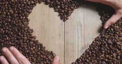 Top view of a cup of Italian coffee on the wooden backdrop with coffee beans to be grinded. Excell