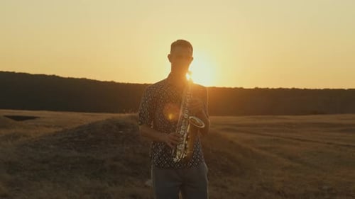Saxophone Player Performs During Beautiful Sunset