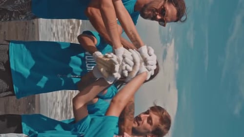 Volunteers Cleaning Beach Together on Sunny Day