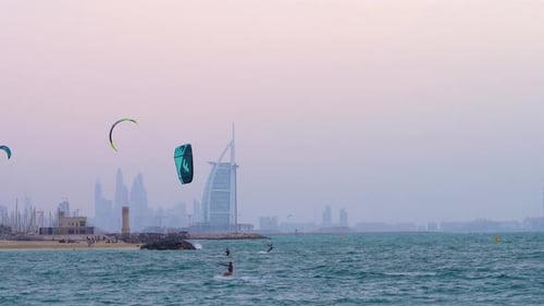 Beautiful sunsets and steady winds make for great kite surfing at Fazza Beach against a backdrop of