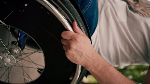 vertical video A man performs tricks on a wheelchair in a city park active lifestyle recreation