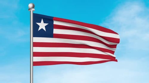 Waving Liberia Flag on Flagpole against Blue Sky