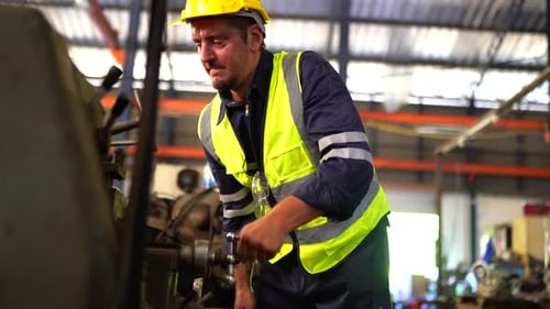 Industrial factory employee working in metal manufacturing industry