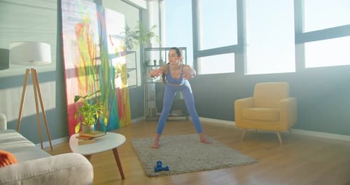 Young Woman Stretching in Bright, Modern Living Room