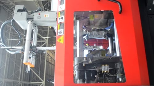 Industrial Robot Arm Operating in Metal Factory