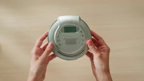 CD Player Using Headphone for Old Music Portable Compact Player Closeup Listen to Music with Vintage