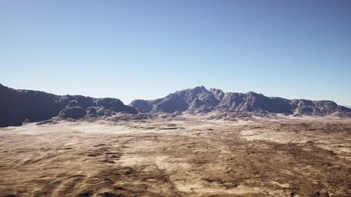 Expansive Dry Plains Under Clear Sky with Rocky Formations and Solitude
