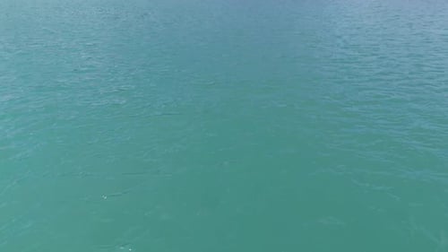 Aerial view of a turquoise river flowing through a wilderness landscape in norway with mountains in