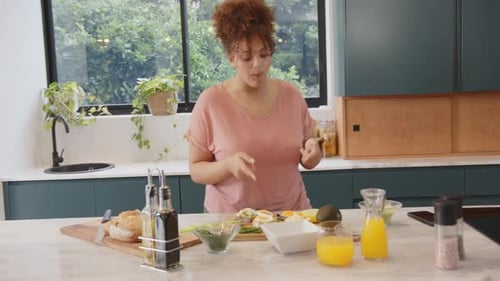 Woman Prepares a Healthy Meal in Kitchen
