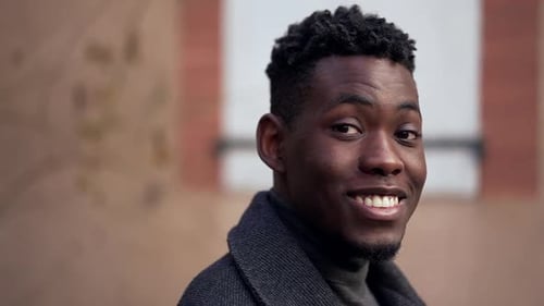 Portrait of a Smiling Young Man in City