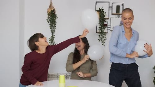 Child and Adults Play with Balloons at Home