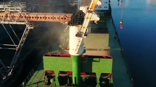Aerial of Wheat Loading to Bulker Ship Cargo Hold at Sea Grain Elevator in Sea Port Wheat Pouring