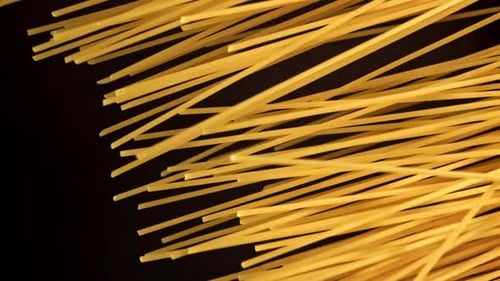Close-up uncooked spaghetti pasta on black background