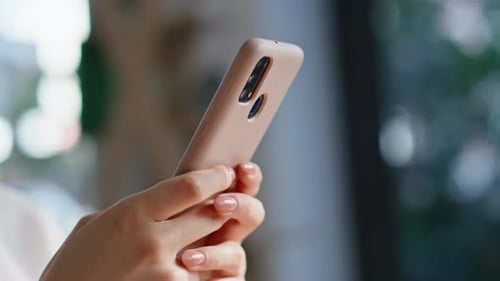 Close up of hands using mobile phone