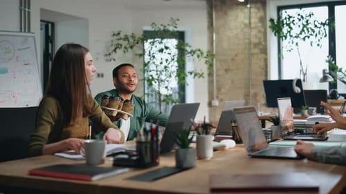 Friendly Worker Bringing Coffee to Coworkers in Coworking Space Office Team