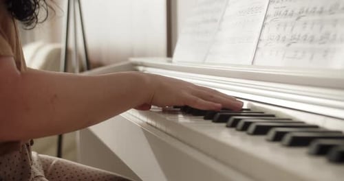 Female Hands Playing Piano Female Hands with Bracelet on Piano Woman Touches Fingers on Keys Close