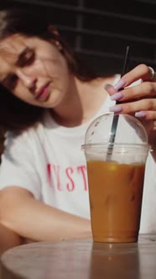 Woman Enjoying an Iced Coffee Drink Outdoors