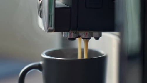 Espresso Machine Fills Gray Mug with Fresh Coffee