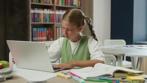 Child Studying with Laptop in Library