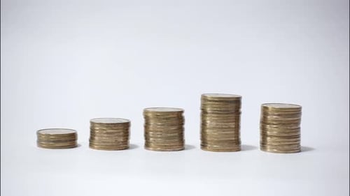 Stacks of Coins Growing on White Background