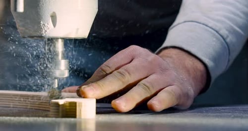 Woodworking Drill Cuts Plywood Shape in Workshop