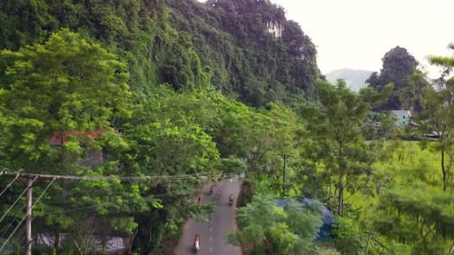 Aerial View Over the Countryside of Asia with a Highway Village and Rice Field