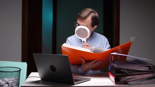 Accountant Examining Documents with Magnifying Glass in Office at Night