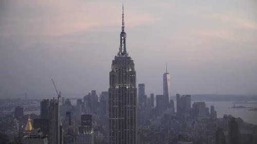 Shining Empire State Building with New York City Skyline at dusk, after sunset in slow motion.
