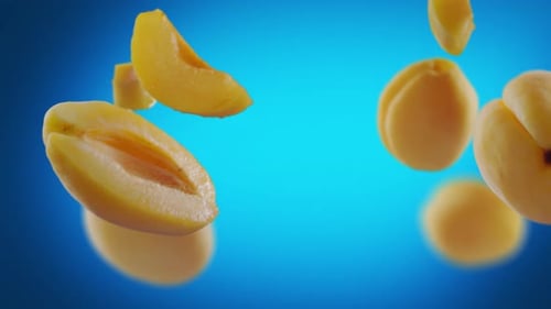 Juicy Apricots Floating on Blue Background