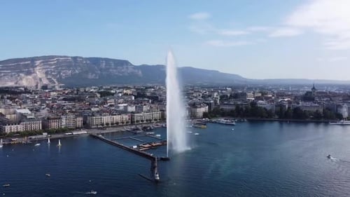 Famous Water Fountain in Geneva, Aerial Reveal with Cityscape and Lake