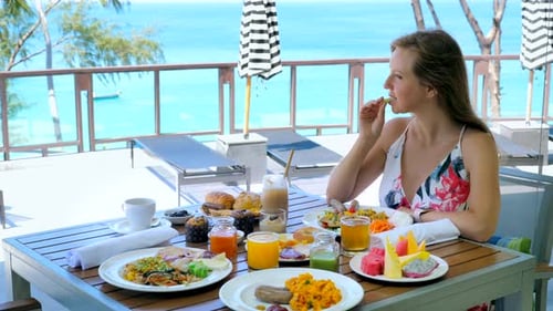Young Woman Eat Breakfast or Brunch in Luxury Outdoors Restaurant at Tropical Resort or Hotel in