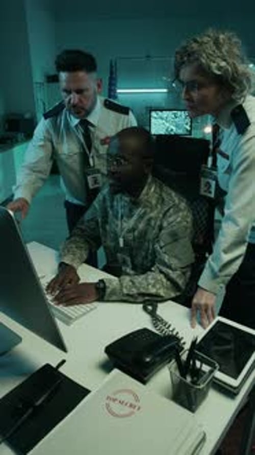 Diverse Army Officers Surveillance Footage on Computer at Command Center